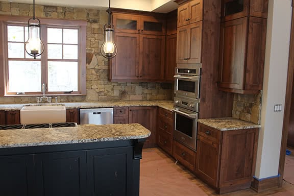 Cozy kitchen with wooden cabinets and granite countertops.